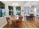 This dining area has a chandelier and large windows with a view of the backyard at 6008 Apex Way, Lady Lake, FL 32159