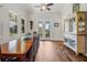 Dining room with a long table, windows overlooking the backyard, and a decorative china cabinet at 6008 Apex Way, Lady Lake, FL 32159