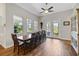 Dining room features a long wood table, ample windows for natural light, and a ceiling fan at 6008 Apex Way, Lady Lake, FL 32159