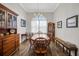 Charming dining room with wood floors, complemented by a stylish chandelier and natural light at 6008 Apex Way, Lady Lake, FL 32159