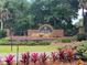 Harbor Hills entrance with brick waterfall feature and colorful landscaping at 6008 Apex Way, Lady Lake, FL 32159