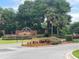 Harbor Hills entrance sign surrounded by lush landscaping at 6008 Apex Way, Lady Lake, FL 32159