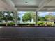 View of a beautiful fountain and manicured landscape through the grand entrance columns at 6008 Apex Way, Lady Lake, FL 32159