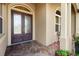 Front door with a brick landing, accent plants, and an American flag at 6008 Apex Way, Lady Lake, FL 32159