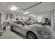 Spacious garage featuring car, bikes, golf cart, and ample storage, ideal for hobbyists and vehicle enthusiasts alike at 6008 Apex Way, Lady Lake, FL 32159