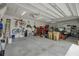 Well-organized garage with bikes, tools, storage cabinets, and a golf cart, perfect for storage and recreational activities at 6008 Apex Way, Lady Lake, FL 32159