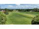 Picturesque view of the well-maintained golf course, lush greenery, and distant water at 6008 Apex Way, Lady Lake, FL 32159