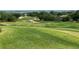Expansive view of the pristine golf course showcasing the lush, rolling green hills and meticulously manicured landscaping at 6008 Apex Way, Lady Lake, FL 32159