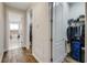 Hallway showing entrances to bathroom and walk-in closet with wood-look tile at 6008 Apex Way, Lady Lake, FL 32159