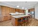 Spacious kitchen with wood cabinets, stainless steel appliances, and an island with a granite countertop at 6008 Apex Way, Lady Lake, FL 32159