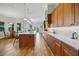 This spacious kitchen has a center island with granite countertop and wooden cabinetry at 6008 Apex Way, Lady Lake, FL 32159