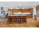 This spacious kitchen has a center island with granite countertop and wooden cabinetry at 6008 Apex Way, Lady Lake, FL 32159