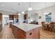 Kitchen with large island, granite countertops, wood cabinets and stainless steel appliances at 6008 Apex Way, Lady Lake, FL 32159