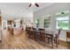 Open kitchen and dining area with wood floors, spacious countertops, and natural light from large windows at 6008 Apex Way, Lady Lake, FL 32159