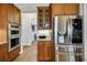 This modern kitchen has a stainless steel refrigerator and wooden cabinetry at 6008 Apex Way, Lady Lake, FL 32159