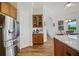 This open concept kitchen has a coffee bar and a stainless steel refrigerator at 6008 Apex Way, Lady Lake, FL 32159