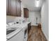Functional laundry room equipped with modern appliances, ample cabinet storage, and a convenient sink at 6008 Apex Way, Lady Lake, FL 32159