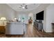 Open living room with wood floors, recessed lighting and a seamless flow to the dining area at 6008 Apex Way, Lady Lake, FL 32159
