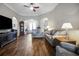 Inviting living room with hardwood floors, neutral walls, and seamless flow to other living spaces at 6008 Apex Way, Lady Lake, FL 32159