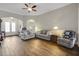 Bright living room with tile flooring, comfortable seating, and a ceiling fan at 6008 Apex Way, Lady Lake, FL 32159