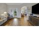 Cozy living room boasts hardwood floors, neutral walls, and seamlessly connects to dining area at 6008 Apex Way, Lady Lake, FL 32159