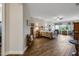 Spacious bedroom with wood-look tile, ceiling fan, and sitting area by the window at 6008 Apex Way, Lady Lake, FL 32159