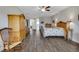Bedroom with tile floors, a ceiling fan, and furnishings including a wardrobe at 6008 Apex Way, Lady Lake, FL 32159