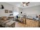 An office area is designed with a sewing machine setup, hardwood floors, and a ceiling fan at 6008 Apex Way, Lady Lake, FL 32159