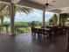 Inviting outdoor patio with comfortable seating, columns, and a scenic view of lush greenery at 6008 Apex Way, Lady Lake, FL 32159