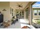 Relax outdoors on the cozy screened-in porch, complete with ample seating and serene views at 6008 Apex Way, Lady Lake, FL 32159