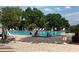 Inviting swimming pool with lounge chairs for relaxation, surrounded by lush greenery at 6008 Apex Way, Lady Lake, FL 32159