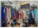 Organized walk-in closet with shelves and rods for ample clothing storage at 6008 Apex Way, Lady Lake, FL 32159