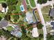 Aerial view showcasing the property's layout, including the house, pool, and surrounding landscape at 604 Ponderosa Dr, St Cloud, FL 34769
