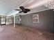 Spacious back porch featuring ceiling fan, decorative columns, and large windows with views of the surrounding property at 604 Ponderosa Dr, St Cloud, FL 34769