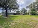This backyard offers a screened pool, shed, and ample room for outdoor enjoyment, with mature trees for privacy at 604 Ponderosa Dr, St Cloud, FL 34769