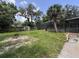 Expansive backyard showcasing a screened pool area, mature trees, lush greenery, and outdoor space perfect for recreation at 604 Ponderosa Dr, St Cloud, FL 34769