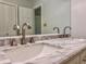 Bathroom featuring double sinks with marble countertop and brushed metal faucets at 604 Ponderosa Dr, St Cloud, FL 34769