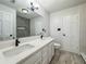 Bathroom featuring double sinks, a large mirror, and tile backsplash at 604 Ponderosa Dr, St Cloud, FL 34769