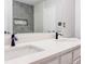 Bright bathroom featuring a dual sink vanity with quartz countertop and modern fixtures at 604 Ponderosa Dr, St Cloud, FL 34769