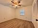 Bedroom featuring wood floors, a ceiling fan, and a closet with double doors at 604 Ponderosa Dr, St Cloud, FL 34769