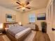 Bedroom with wooden bed, wood floors, lamps, and decor at 604 Ponderosa Dr, St Cloud, FL 34769