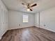Bedroom with wood floors, ceiling fan and closet with double doors at 604 Ponderosa Dr, St Cloud, FL 34769