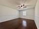 Spacious bedroom with hardwood floors, a ceiling fan, and ample natural light at 604 Ponderosa Dr, St Cloud, FL 34769