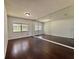 Spacious bedroom with dark hardwood flooring, windows, and a mirrored wall at 604 Ponderosa Dr, St Cloud, FL 34769