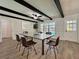 Contemporary dining room with a ceiling fan, black ceiling beams, and view to the pool at 604 Ponderosa Dr, St Cloud, FL 34769