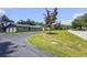 Charming single-story home with a well-manicured lawn, mature trees, and a long driveway at 604 Ponderosa Dr, St Cloud, FL 34769
