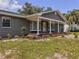 Charming single-story home with well-maintained lawn and inviting front entrance with columns at 604 Ponderosa Dr, St Cloud, FL 34769