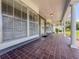 Spacious front porch with tile flooring and classic white columns, offering a welcoming outdoor space at 604 Ponderosa Dr, St Cloud, FL 34769