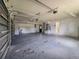 Large garage provides ample storage and workspace, featuring multiple doors, overhead lighting, and a neutral color palette at 604 Ponderosa Dr, St Cloud, FL 34769