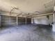 Spacious three-car garage with painted floor and walls, overhead door openers, and plenty of room for storage at 604 Ponderosa Dr, St Cloud, FL 34769